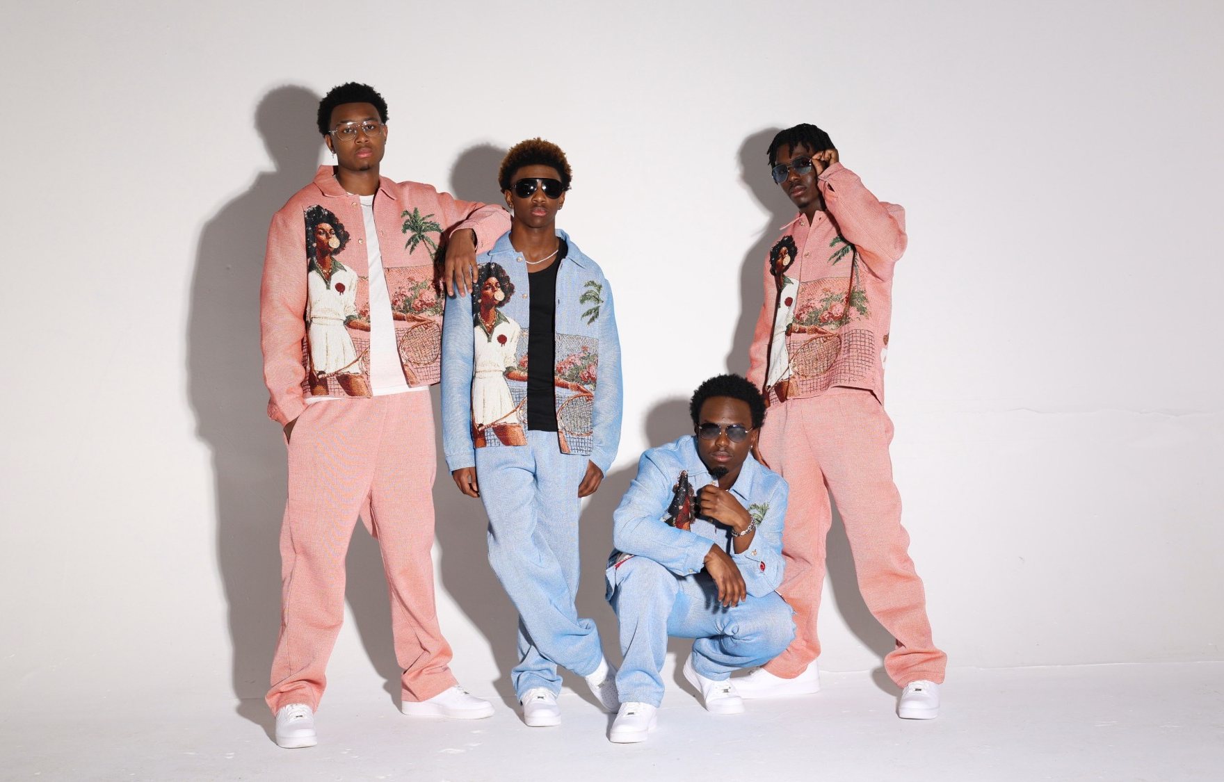 WanMor — the four members in pink and blue tailoring, photographed in studio